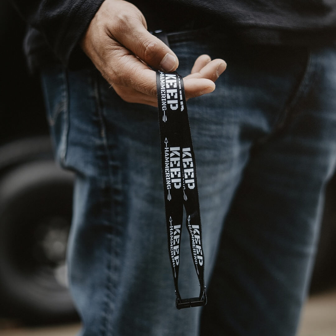 Person holding a black lanyard with 'KEEP' branding.